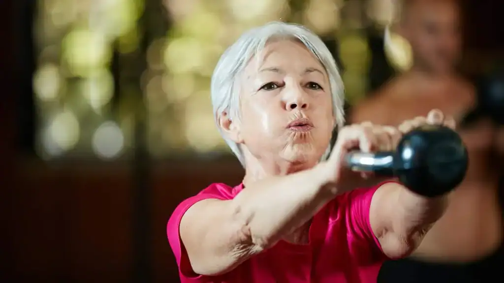Toning Arms After 60: Empowering Womens Fitness Through Effective Weight Training 1 Older woman doing weight training Ascot to help her strength and longevity