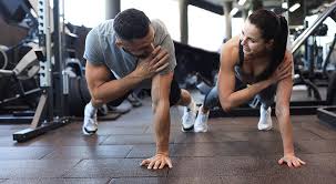 Image of man and woman doing Cardio Ascot to tone their arms. 